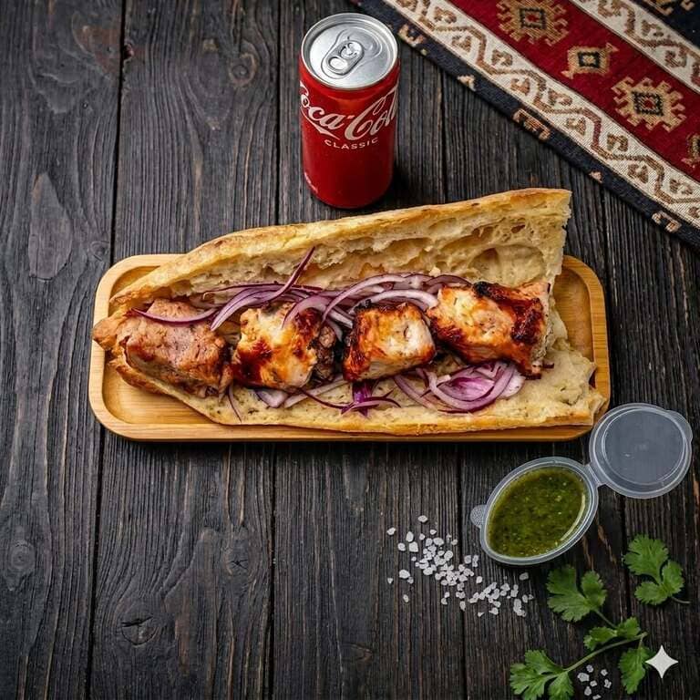 Pork mtsvadi served in fresh bread with herb sauce